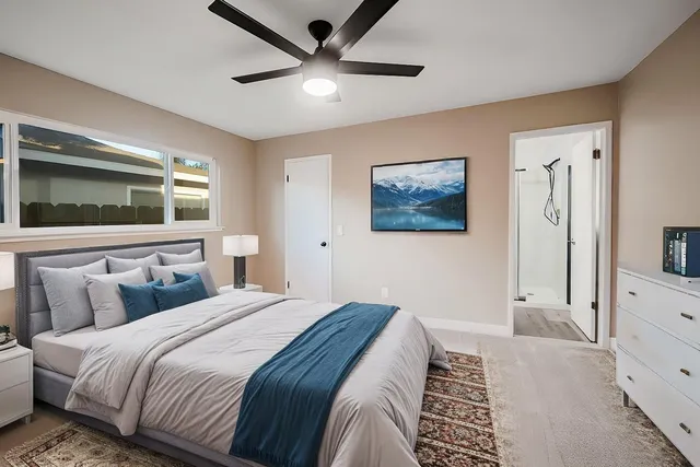 a bedroom with a large bed and a flat screen tv