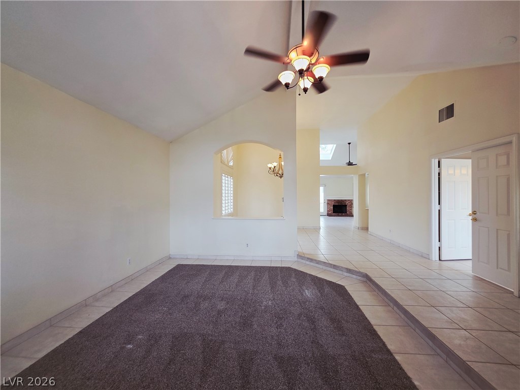 2920 Setting Sun Street Las Vegas, NV 89117 - Photo 9 of 43 This airy interior boasts vaulted ceilings and a clear view to the fireplace, creating a bright atmosphere.