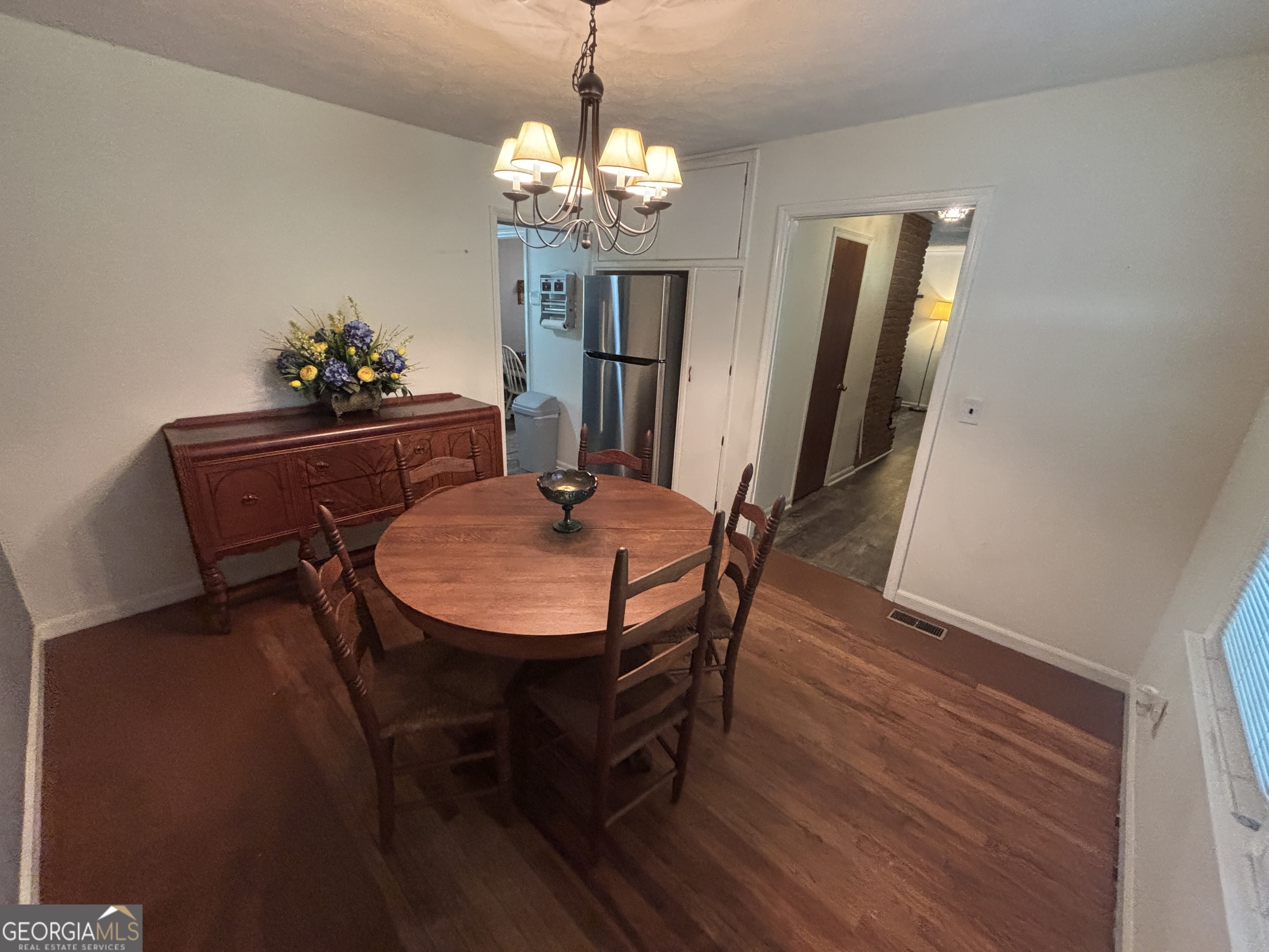 152 Crest Drive Cochran, GA 31014 - Photo 6 of 54 a view of a dining room with furniture and chandelier