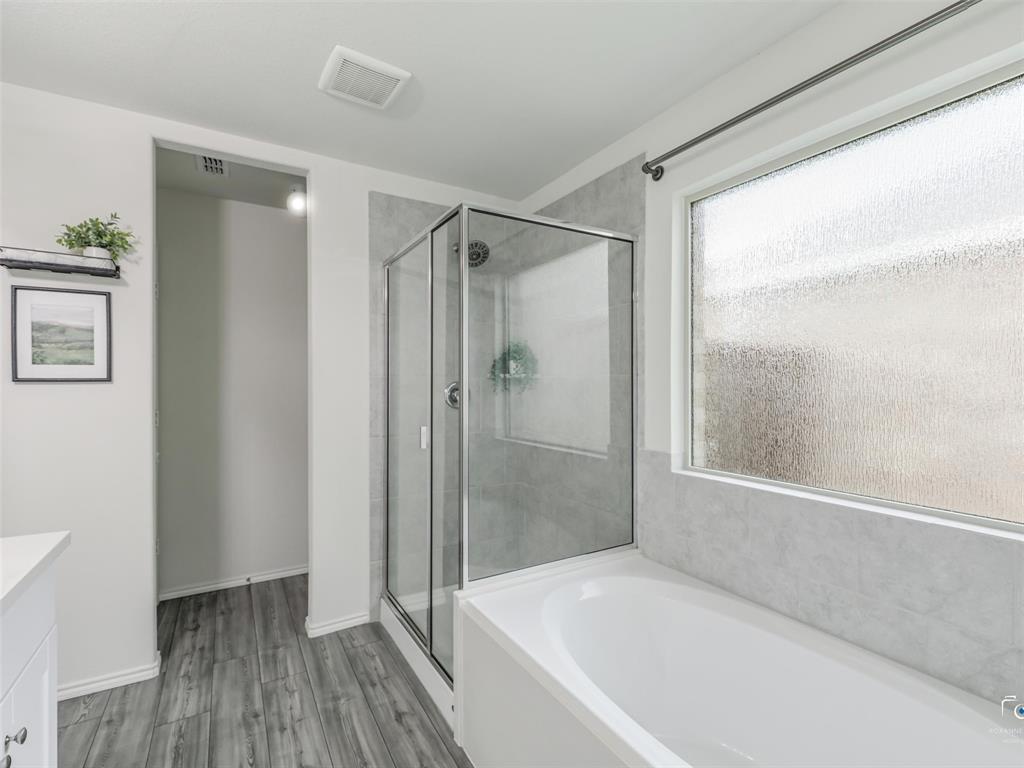 4517 Ashmark Road Aubrey, TX 76227 - Photo 14 of 26 a bathroom with a bathtub and a shower