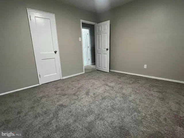 an empty room with closet area