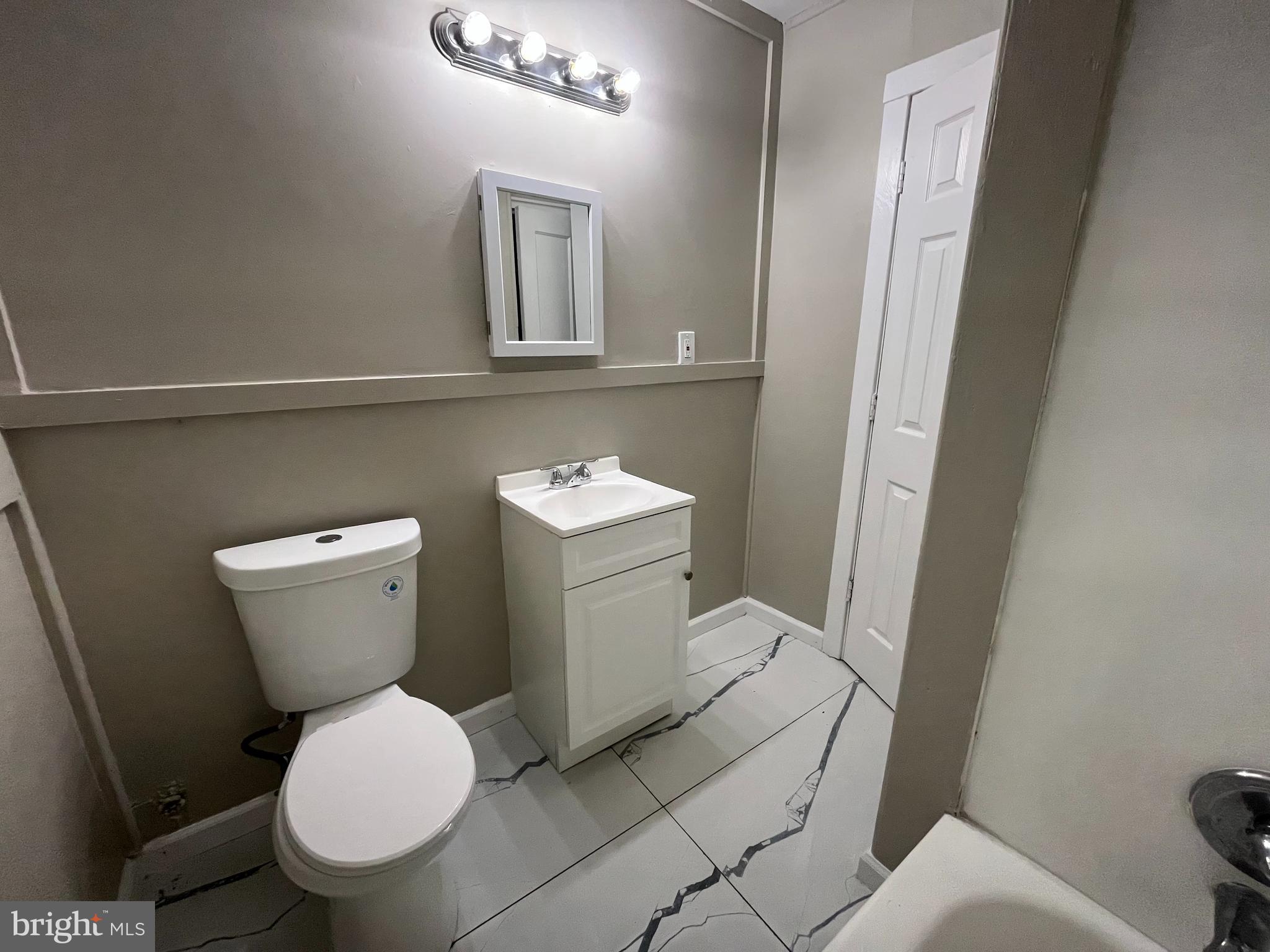 219 Kinsley Road Pemberton, NJ 08068 - Photo 14 of 22 a white toilet sitting next to a bathroom sink