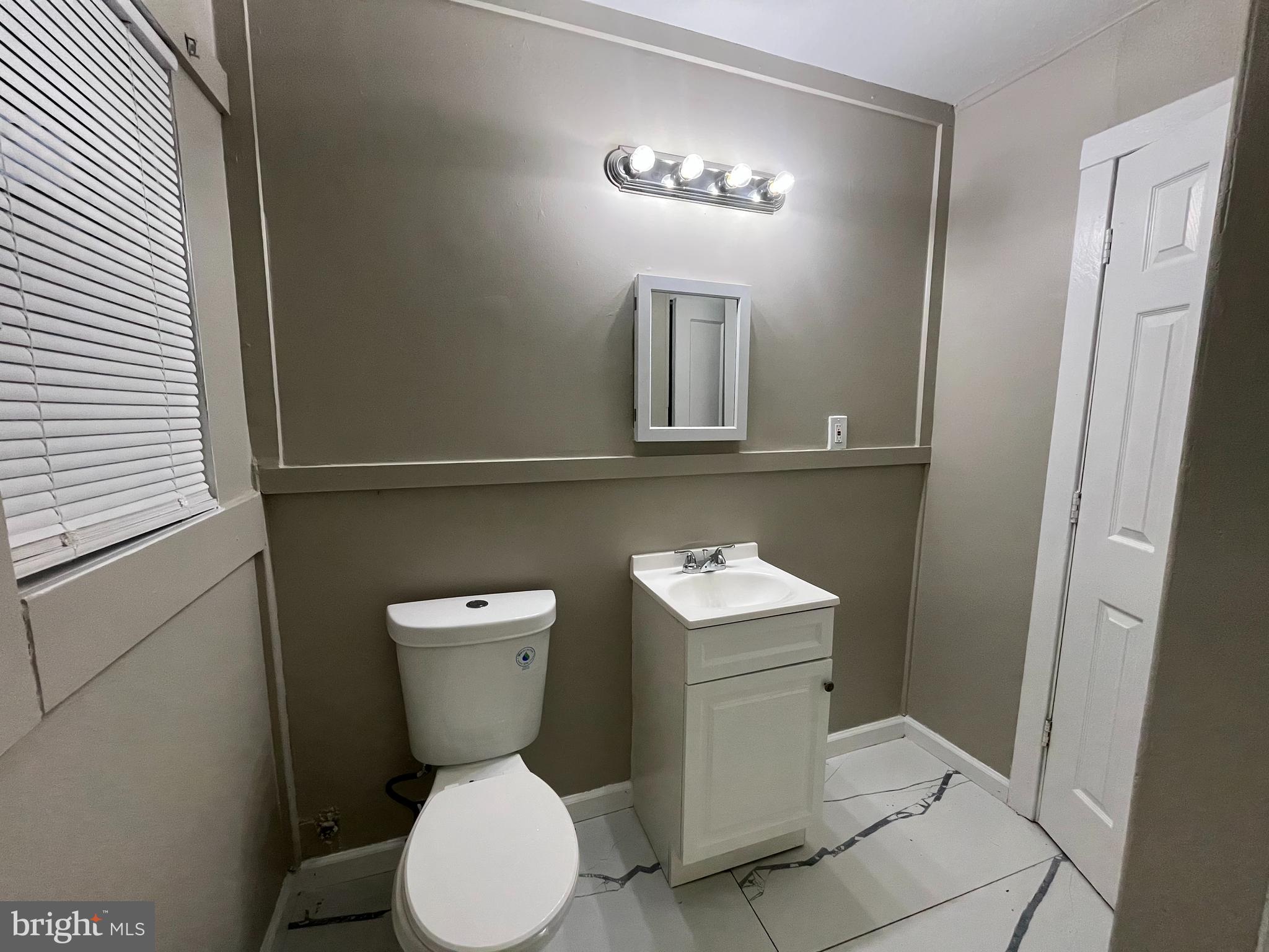 219 Kinsley Road Pemberton, NJ 08068 - Photo 15 of 22 a bathroom with a toilet a sink and mirror