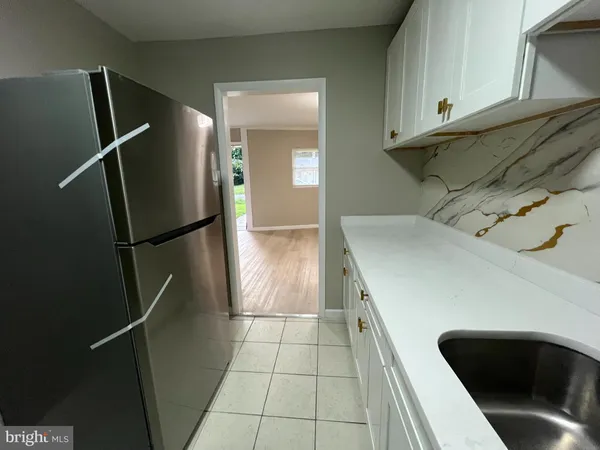 a kitchen with a refrigerator and cabinets
