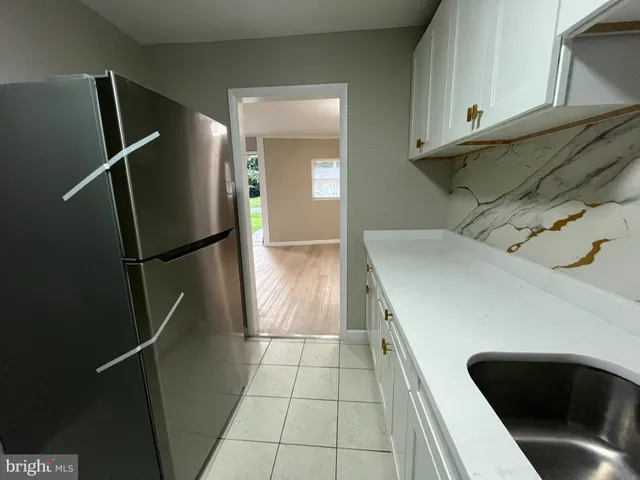 a kitchen with a refrigerator and cabinets