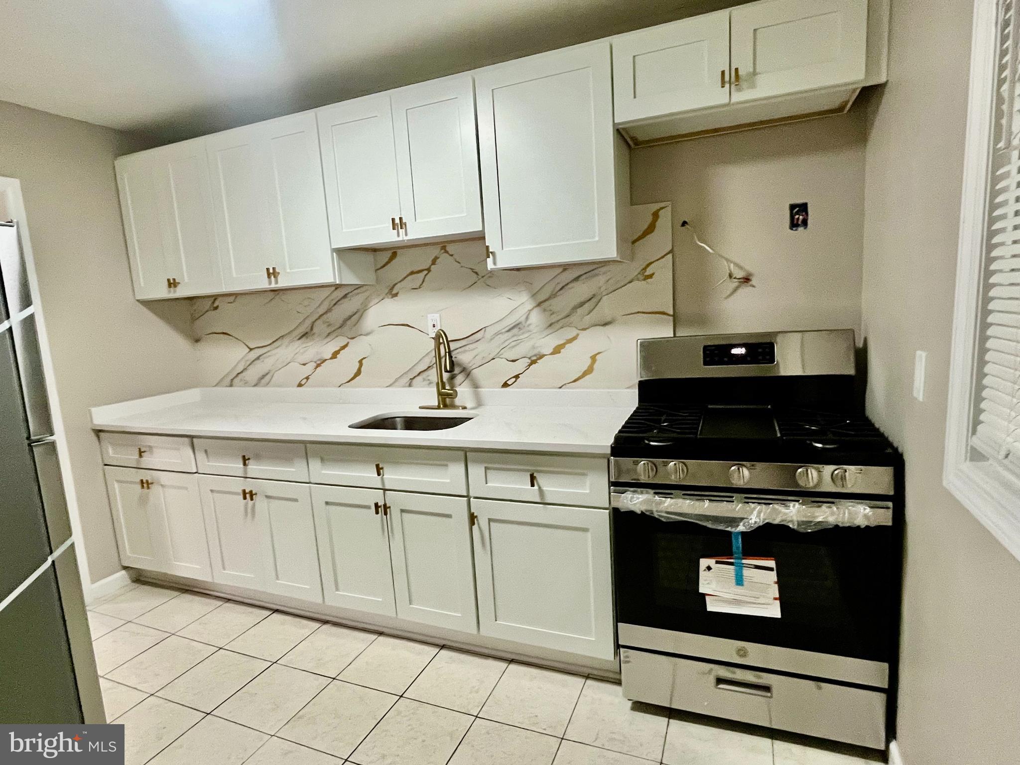 219 Kinsley Road Pemberton, NJ 08068 - Photo 4 of 22 a kitchen with granite countertop white cabinets and appliances