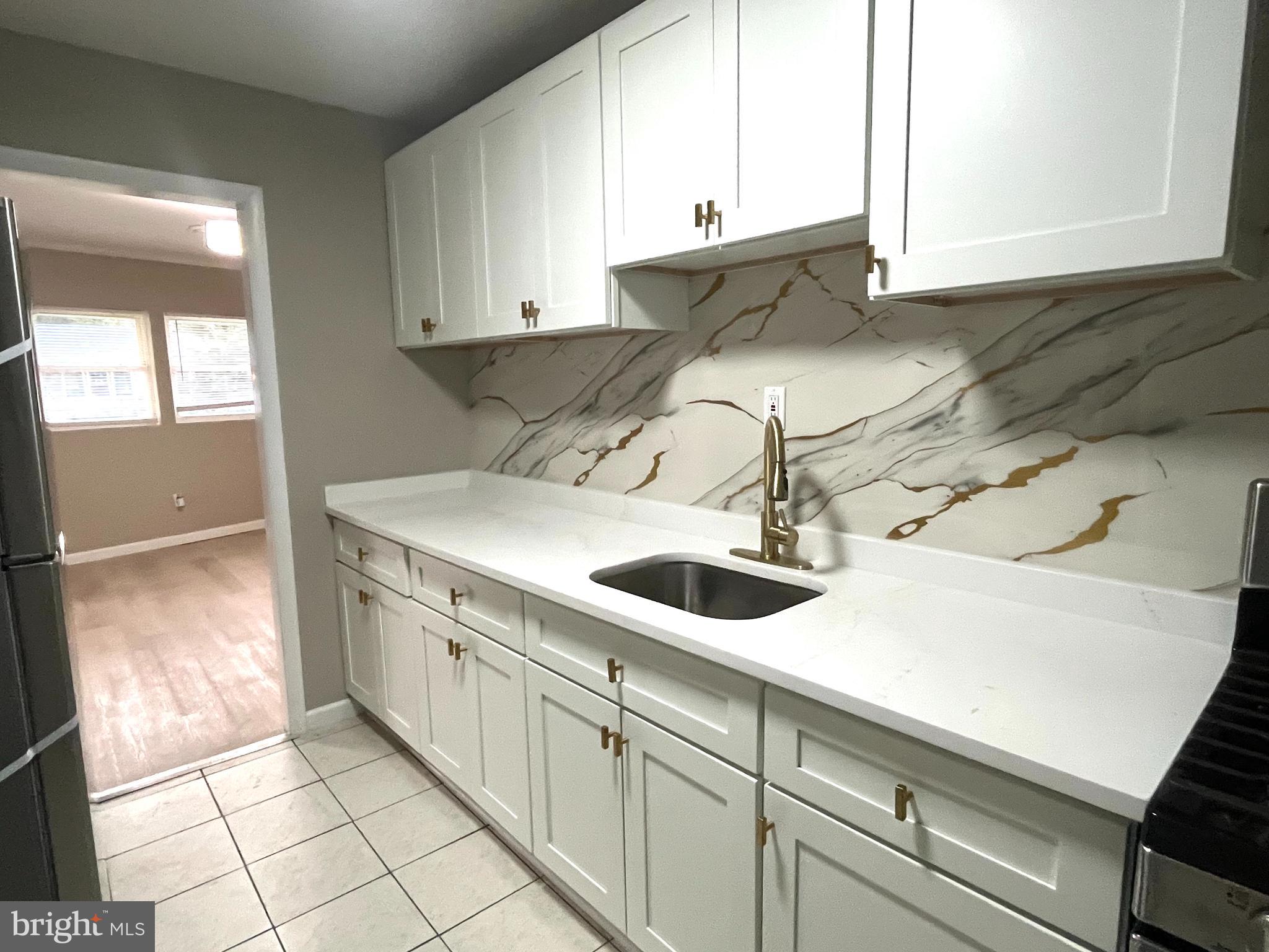219 Kinsley Road Pemberton, NJ 08068 - Photo 5 of 22 a kitchen with a sink and a cabinets
