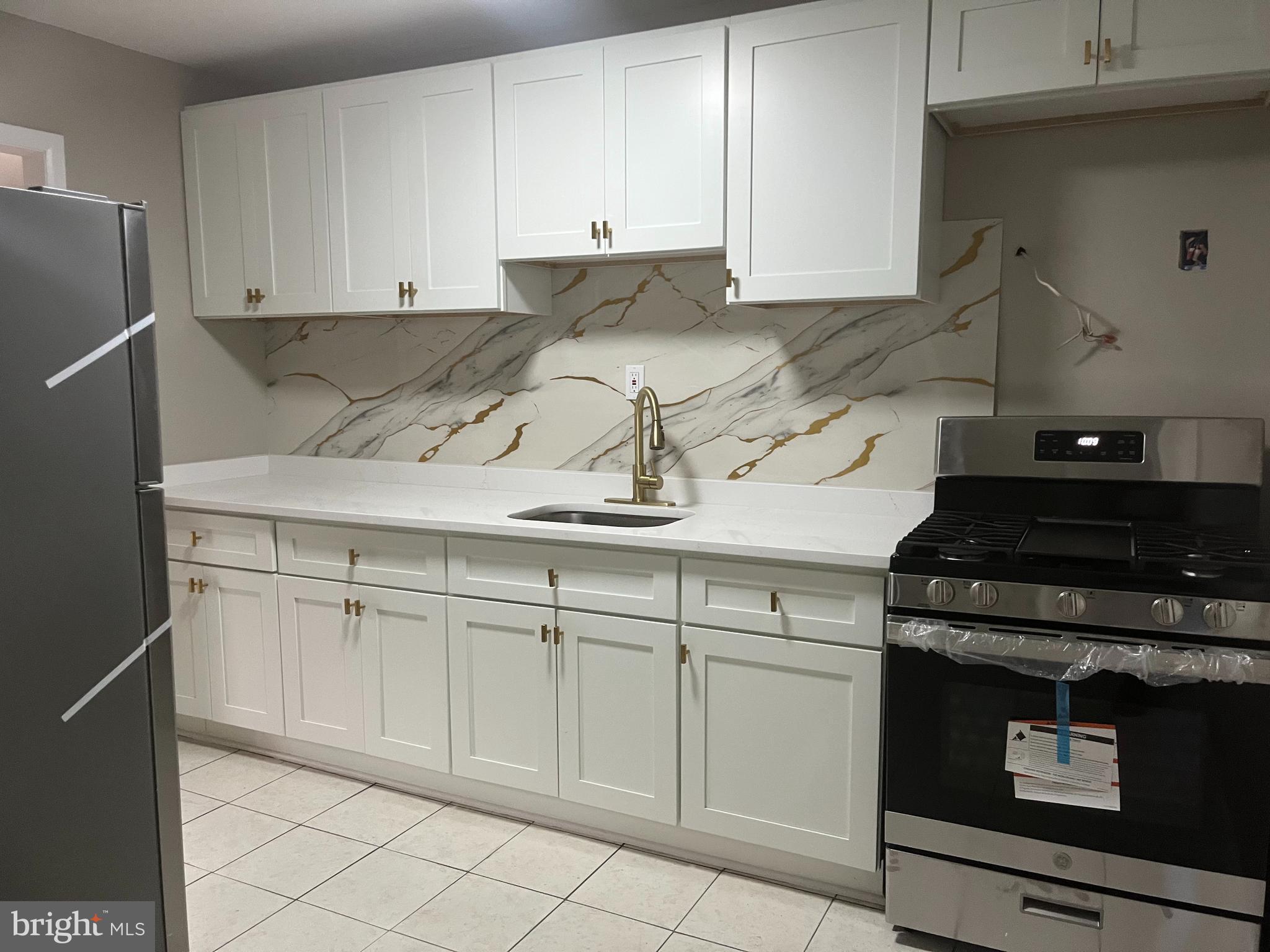 219 Kinsley Road Pemberton, NJ 08068 - Photo 7 of 22 a kitchen with white cabinets and appliances