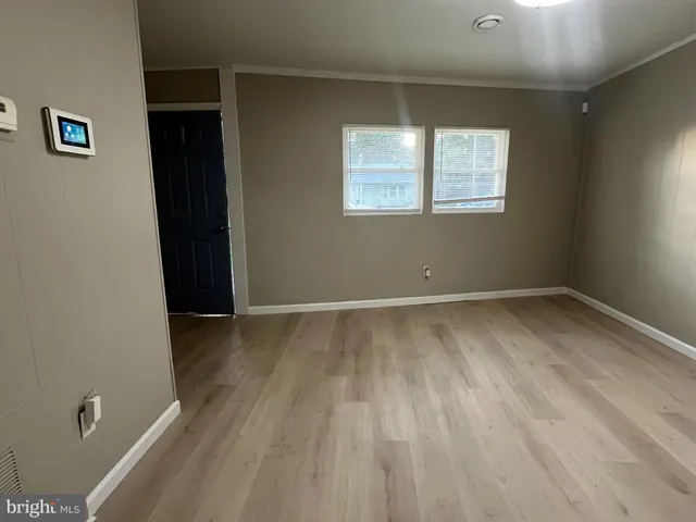 a view of room with window and hardwood floor