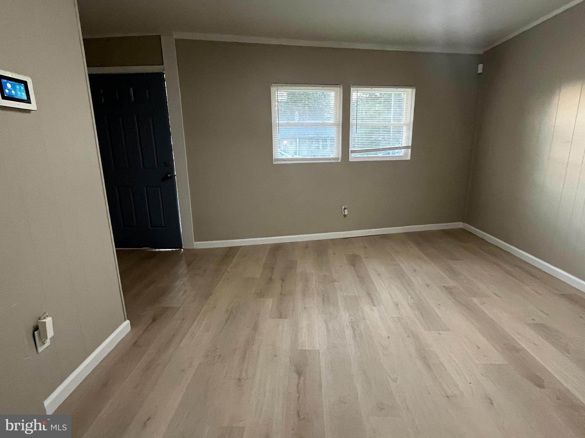 219 Kinsley Road Pemberton, NJ 08068 - Photo 9 of 22 an empty room with wooden floor and windows