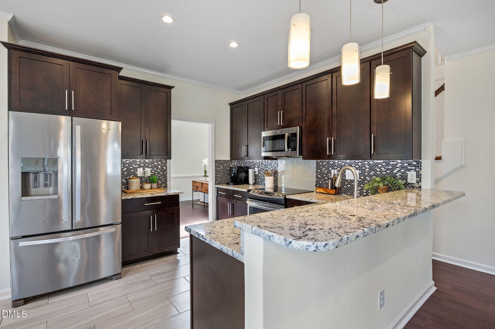 5512 Banwell Place Raleigh, NC 27613 - Photo 12 of 47 a kitchen with kitchen island granite countertop wooden cabinets a refrigerator and a stove