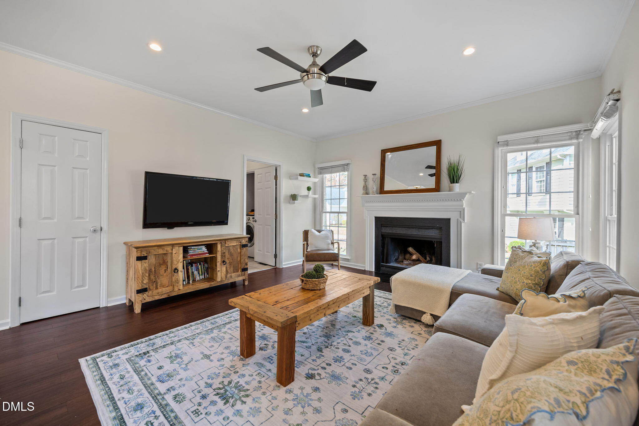 5512 Banwell Place Raleigh, NC 27613 - Photo 20 of 47 a living room with furniture a flat screen tv and a fireplace