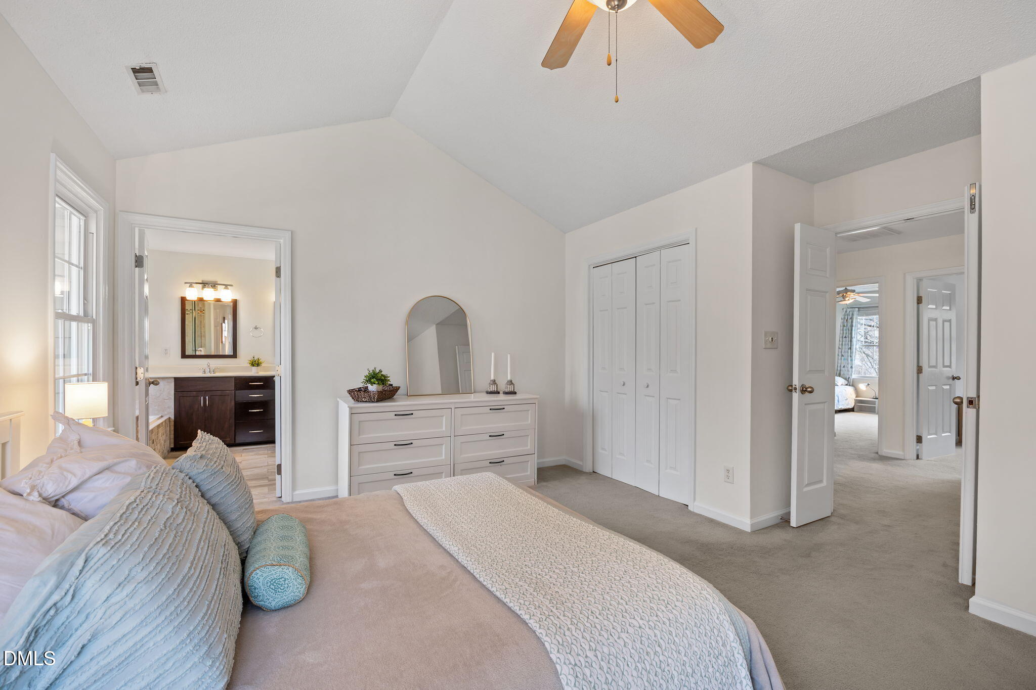 5512 Banwell Place Raleigh, NC 27613 - Photo 24 of 47 a bedroom with a bed and a chandelier