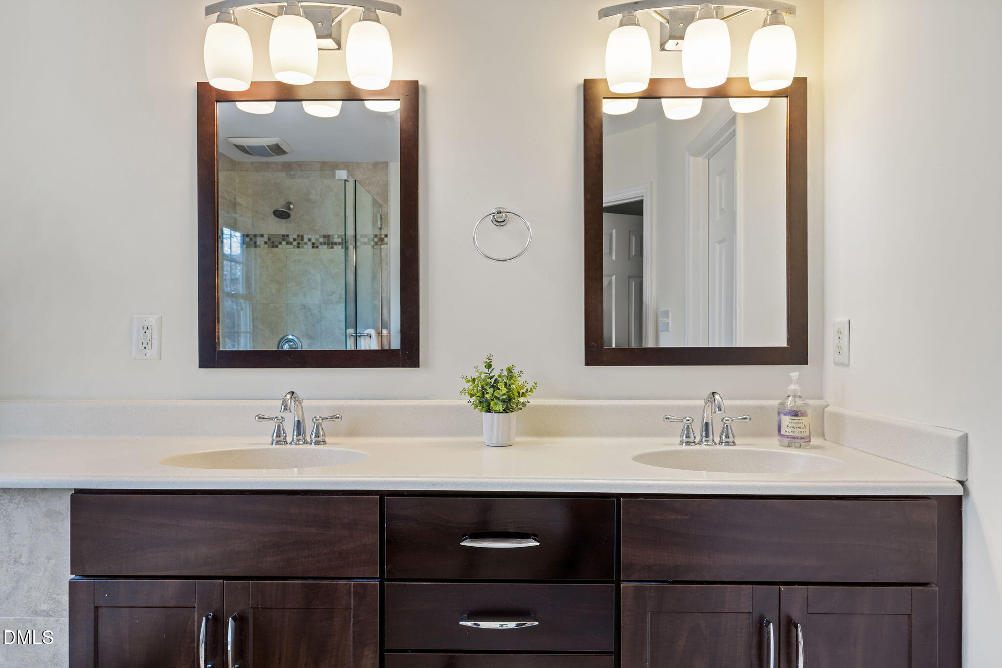 5512 Banwell Place Raleigh, NC 27613 - Photo 26 of 47 a bathroom with double vanity sinks and a mirror