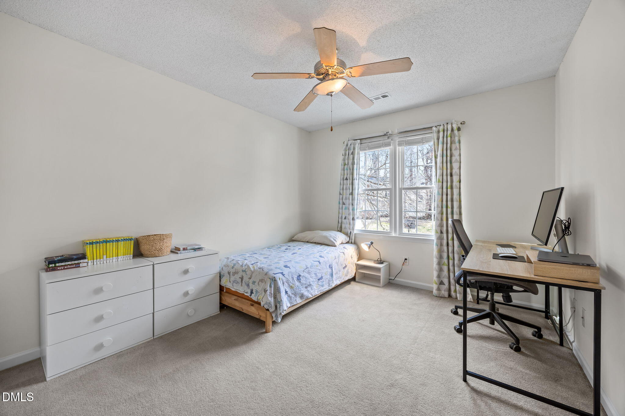 5512 Banwell Place Raleigh, NC 27613 - Photo 29 of 47 a bedroom with a bed and a window