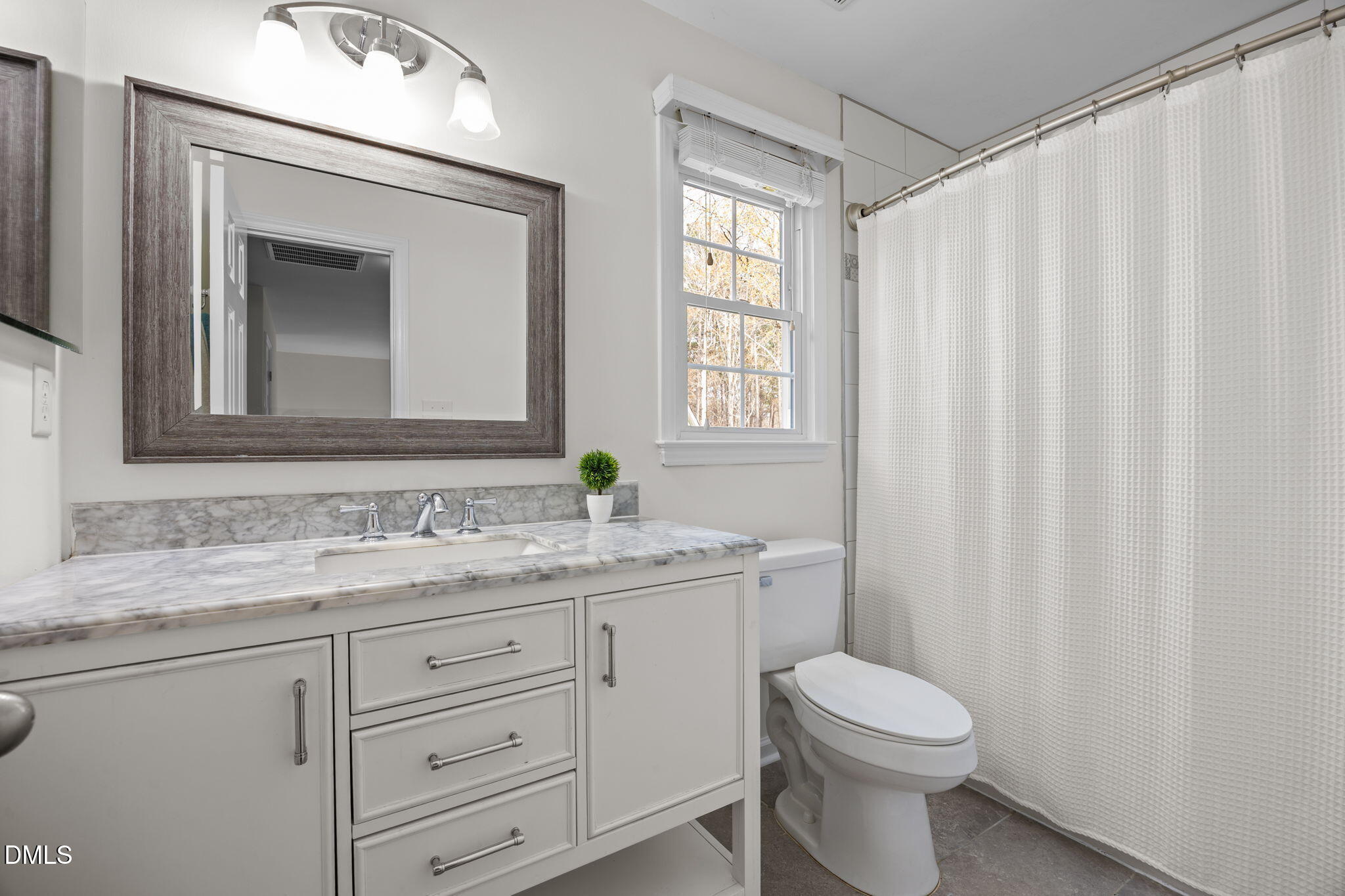 5512 Banwell Place Raleigh, NC 27613 - Photo 31 of 47 a bathroom with a granite countertop toilet sink and mirror