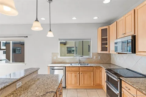 a workspace with a fireplace a sink and a chandelier