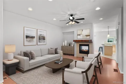 a living room with furniture a fireplace and a flat screen tv