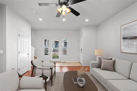 a living room with furniture and a chandelier