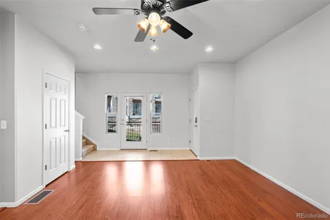 a kitchen with stainless steel appliances granite countertop a stove a sink a refrigerator and chairs