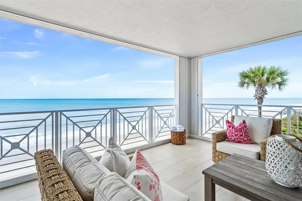 a living room with furniture and floor to ceiling window