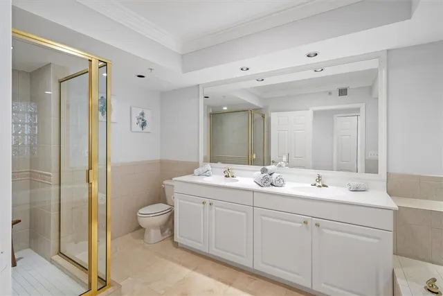 a spacious bathroom with a double vanity sink mirror and toilet