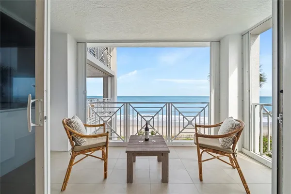 a view of a chairs and table in a balcony