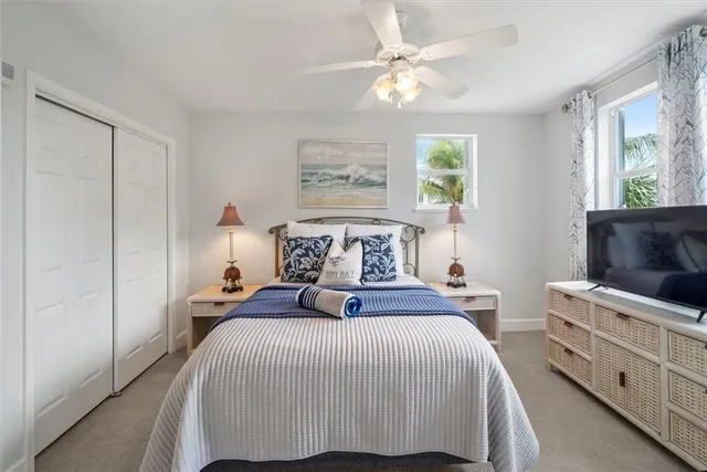 a bedroom with a bed and a television