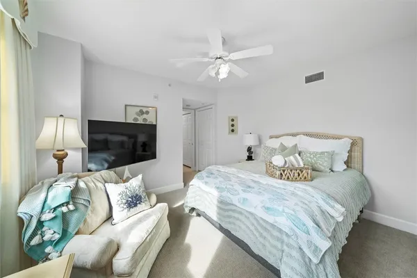 a bedroom with a bed and a television