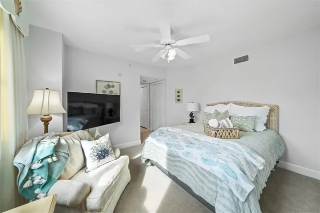 a kitchen with refrigerator and chairs