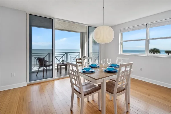 a view of a dining room with furniture window and wooden floor