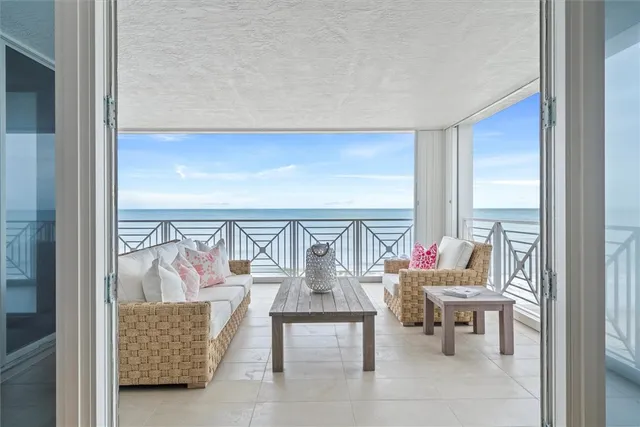a living room with furniture and a floor to ceiling window
