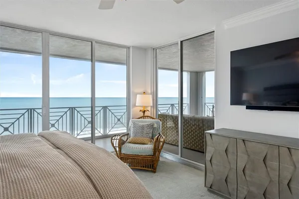 a bedroom with furniture and a flat screen tv