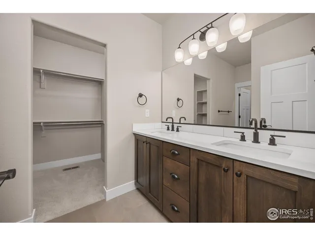 a bathroom with a double vanity sink and mirror