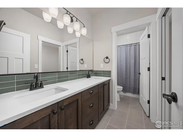 a bathroom with a double vanity sink mirror and double