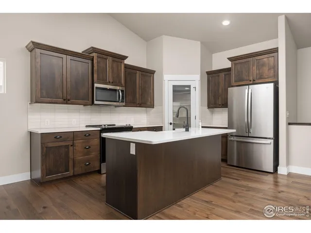 a kitchen with stainless steel appliances and wooden cabinets