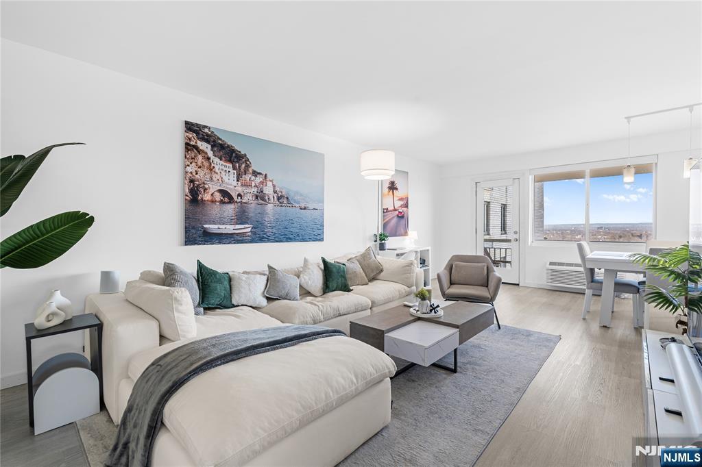 a living room with furniture and a painting on the wall