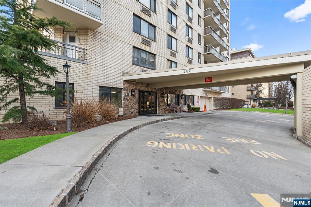 307 Prospect Avenue, Unit 17D Hackensack, NJ 07601 - Photo 28 of 29 a front view of a building and a yard