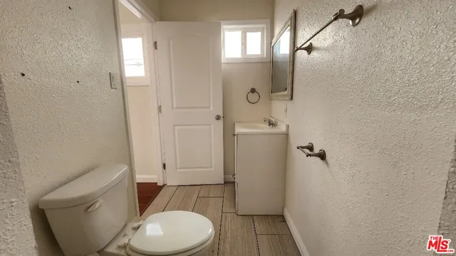 a bathroom with a shower sink and mirror