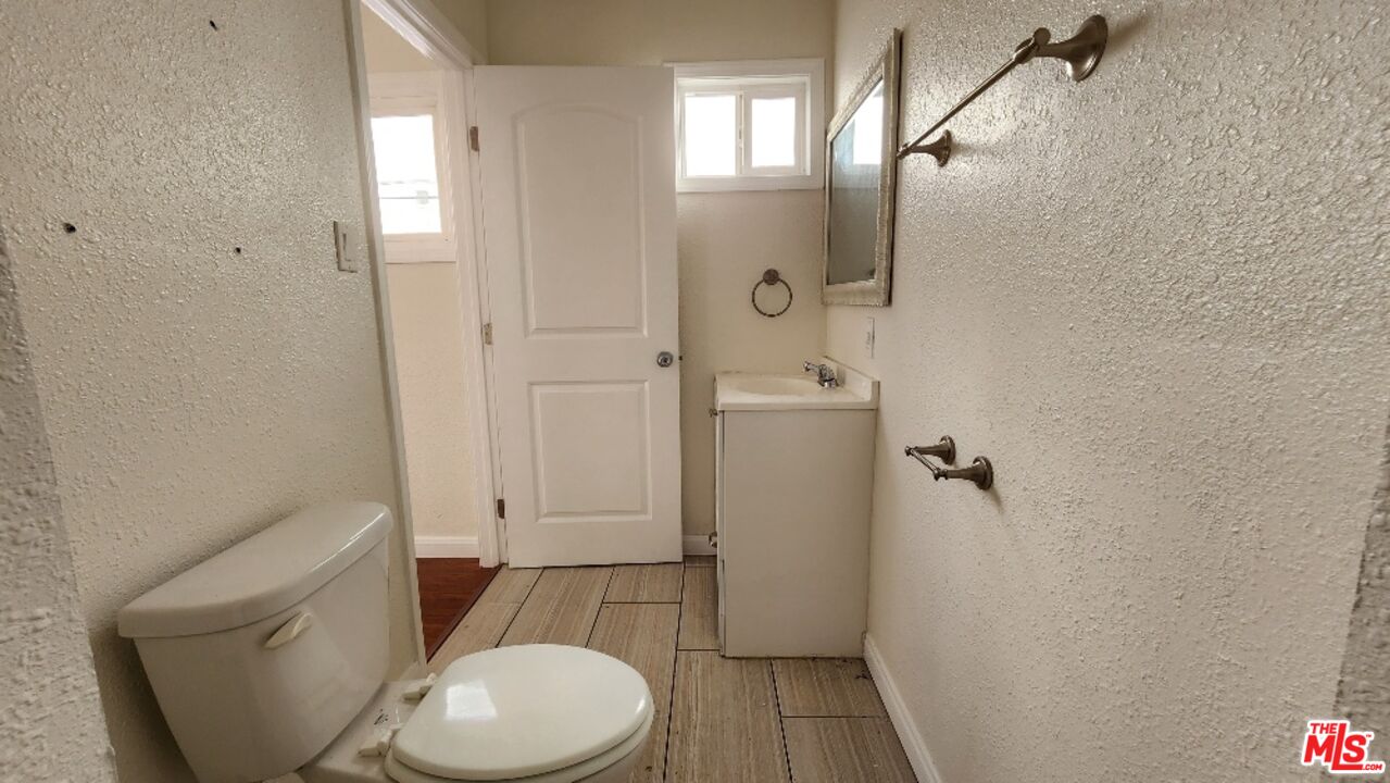 251 West 41st Place Los Angeles, CA 90037 - Photo 17 of 18 a bathroom with a toilet and a shower