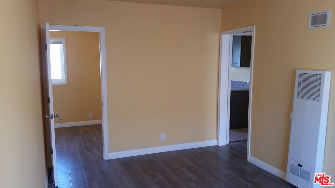 251 West 41st Place Los Angeles, CA 90037 - Photo 3 of 18 an empty room with wooden floor and closet