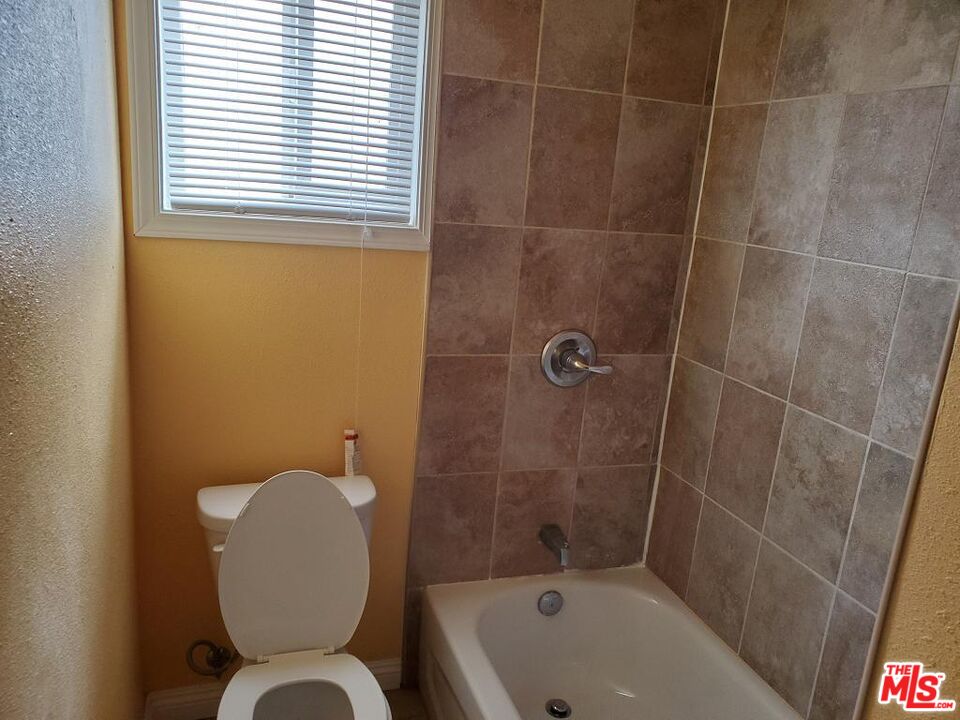 251 West 41st Place Los Angeles, CA 90037 - Photo 5 of 18 a bathroom with a toilet and shower