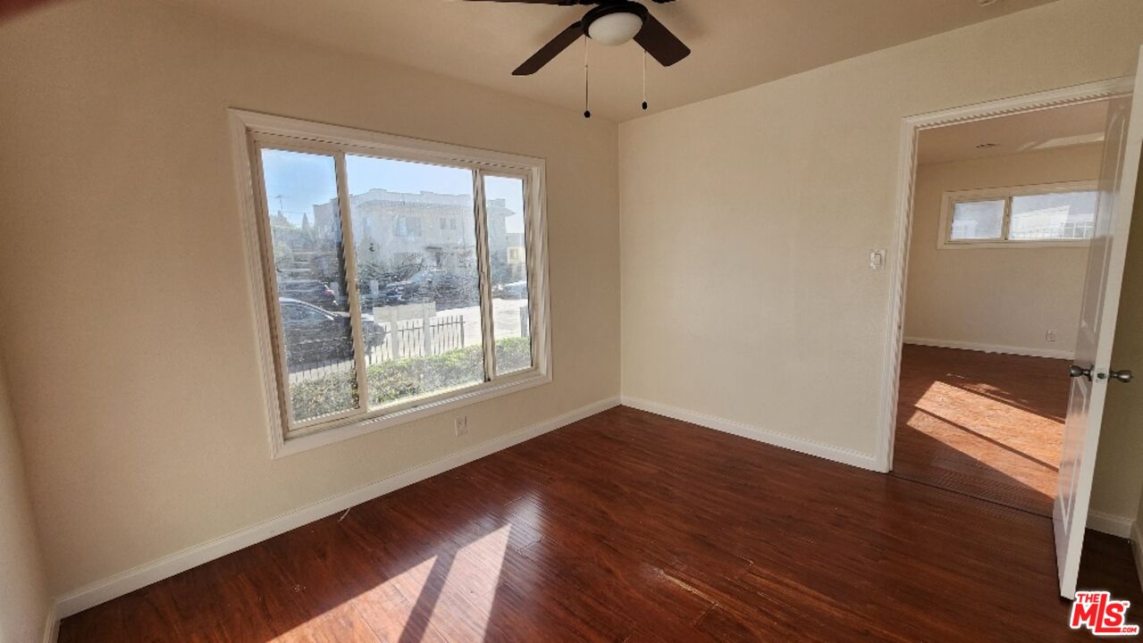 251 West 41st Place Los Angeles, CA 90037 - Photo 9 of 18 a view of an empty room with wooden floor and a window