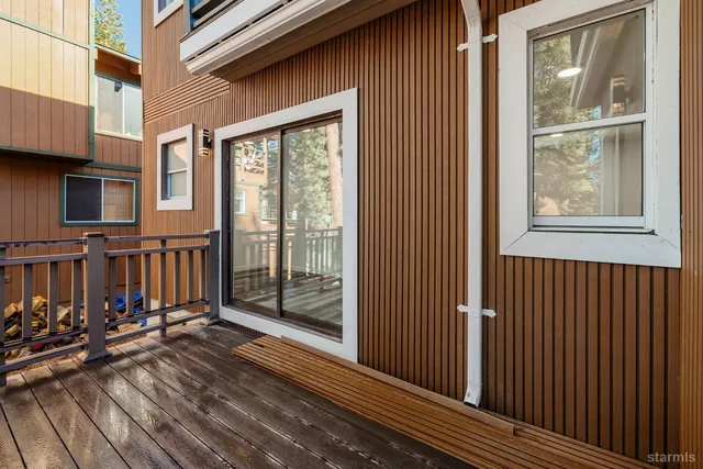 a view of a balcony with wooden floor and fence