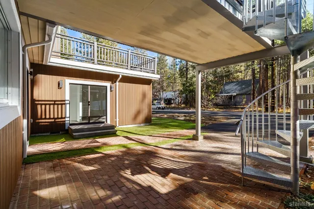a view of a house with backyard porch and wooden fence