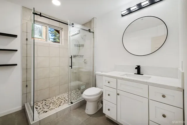 a bathroom with a toilet a sink and a mirror