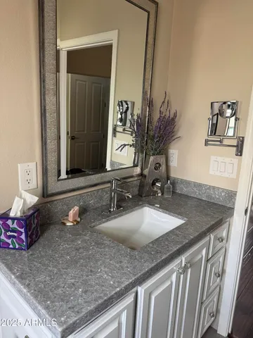 a bathroom with a sink and mirror