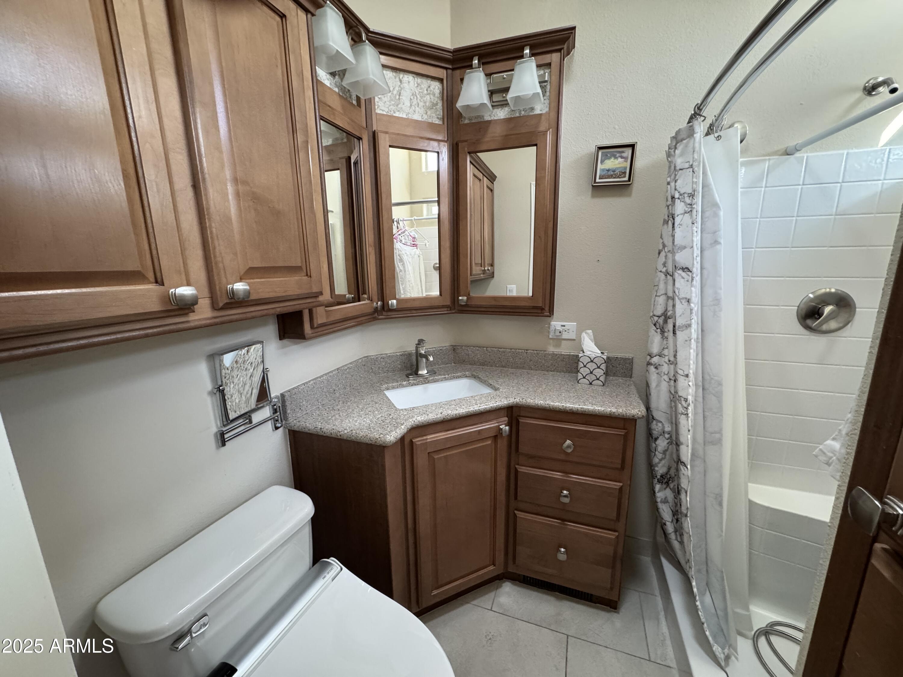 1279 South Sioux Drive Apache Junction, AZ 85119 - Photo 20 of 34 a bathroom with a granite countertop sink toilet and shower