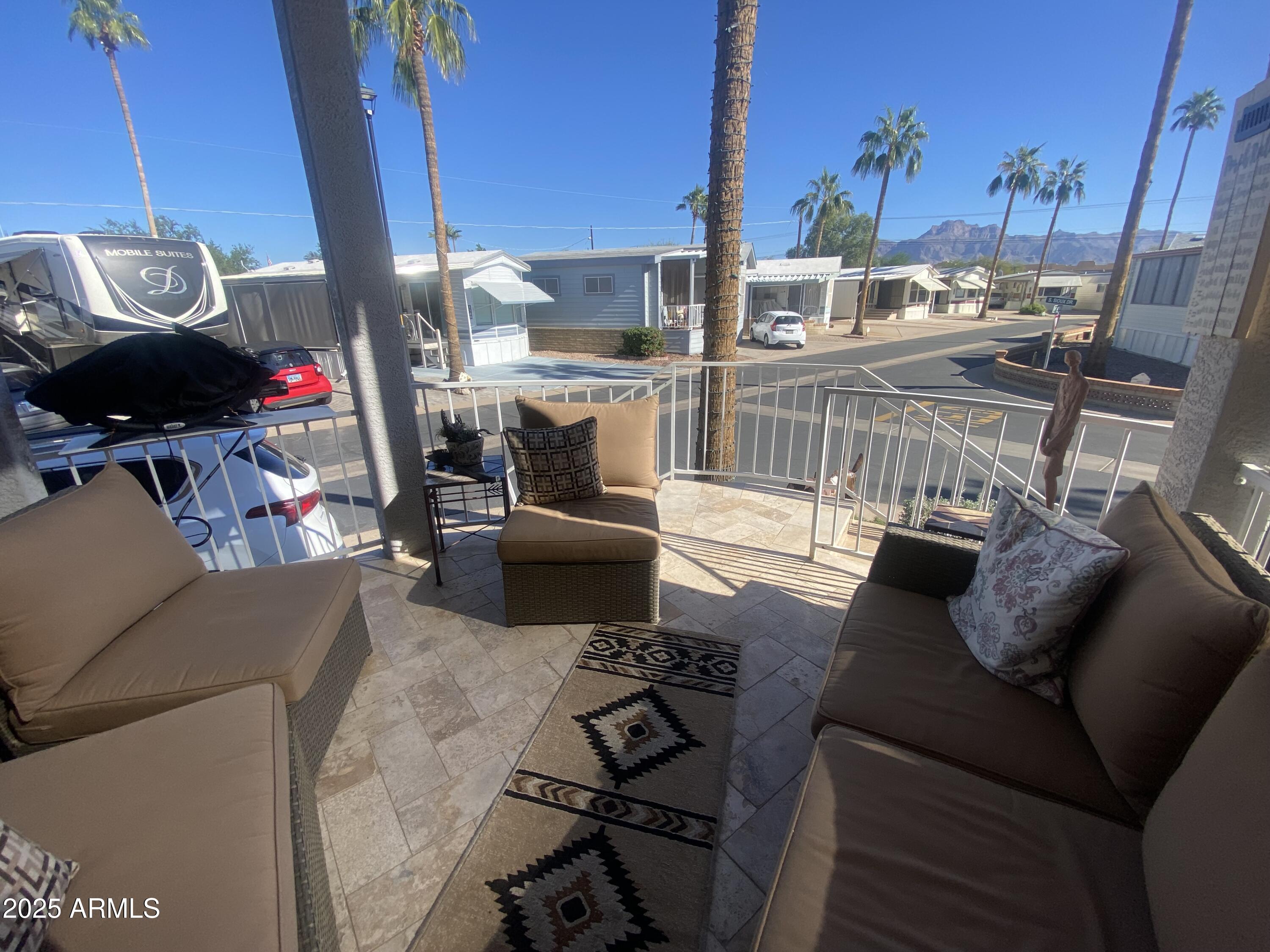 1279 South Sioux Drive Apache Junction, AZ 85119 - Photo 6 of 34 a living room with furniture and a floor to ceiling window