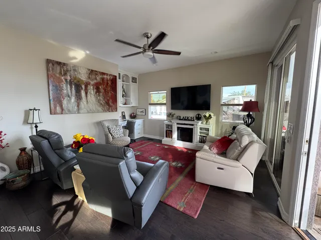 a kitchen with granite countertop a sink a stove a dining table and chairs